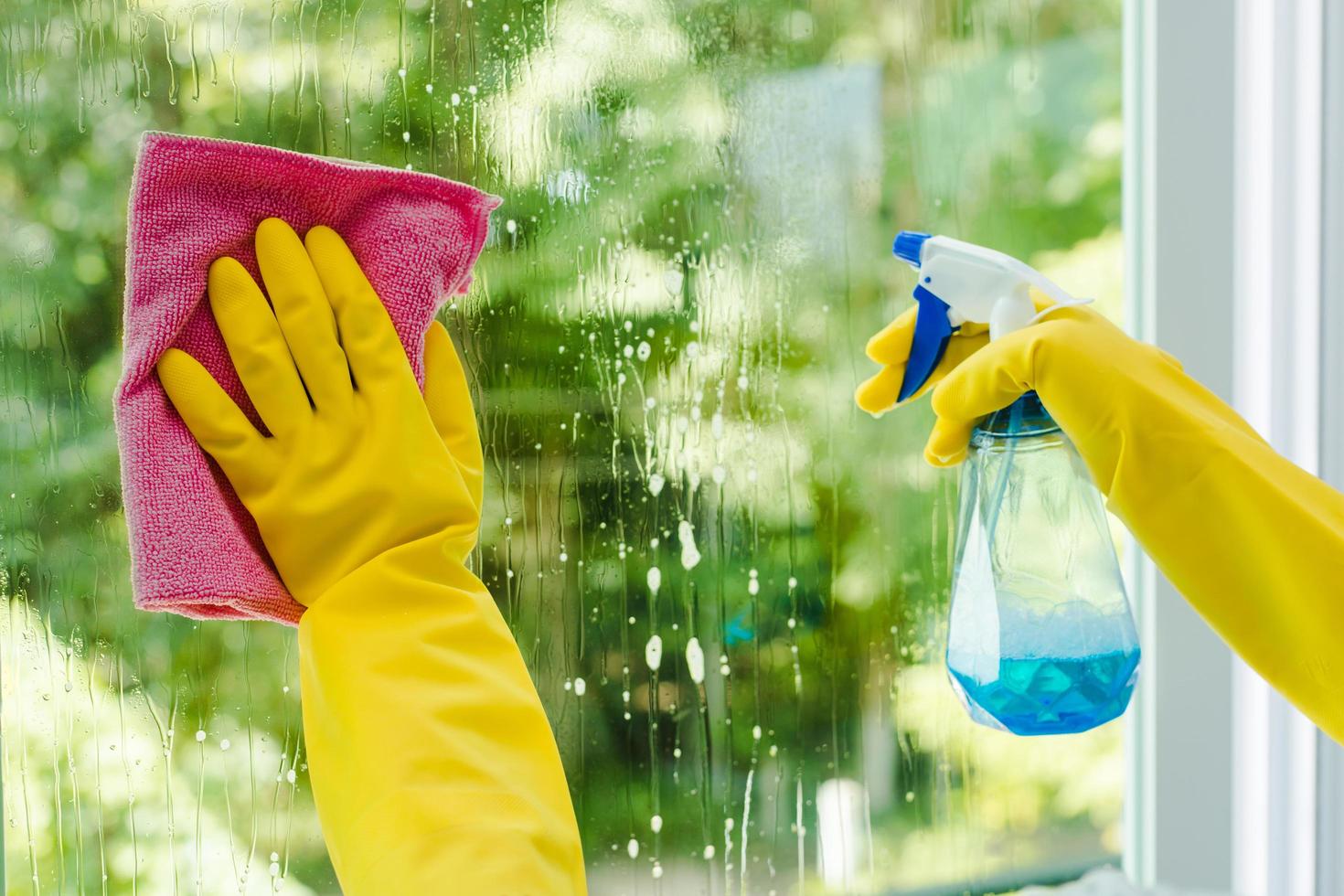 woman-spraying-and-wiping-glass-free-photo.jpg